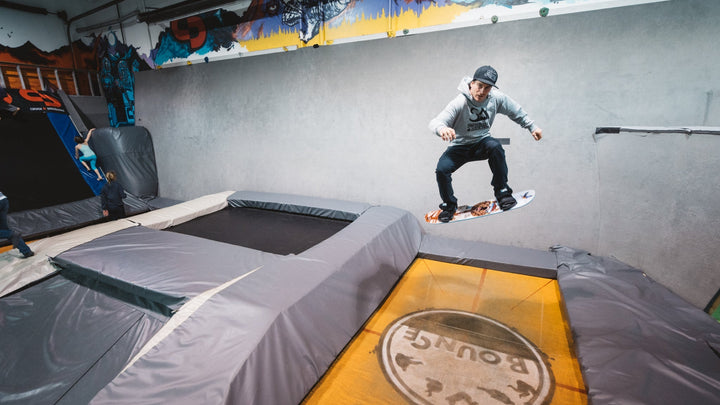 How To Frontside & Cab 180 On A Tramp Board - Snowboard Addiction